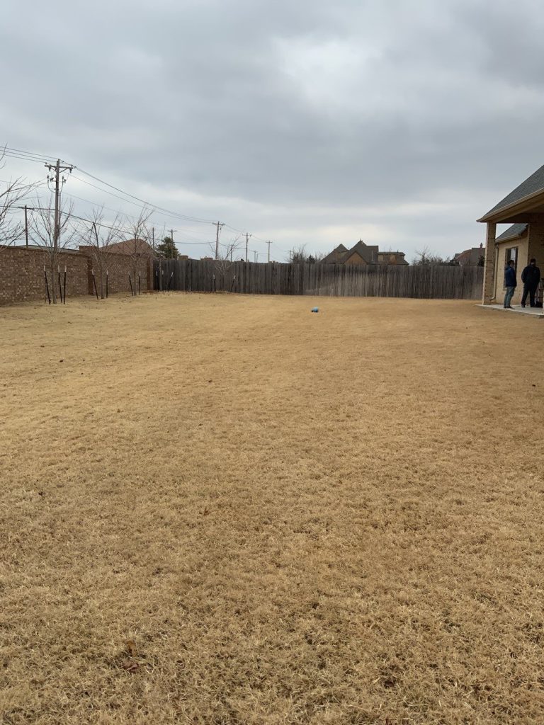 Open backyard area before custom pool and spa construction in Oak Tree East Edmond Oklahoma.