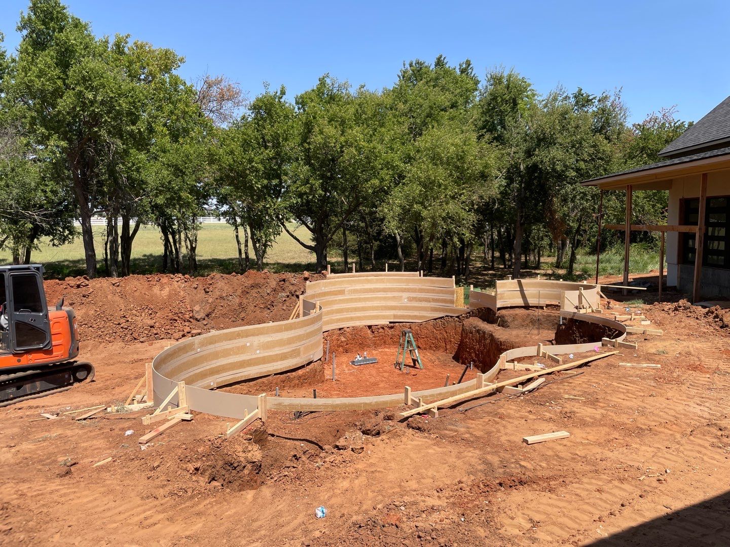 Freeform pool excavation and steel reinforcement during construction in Villagio Edmond Oklahoma.