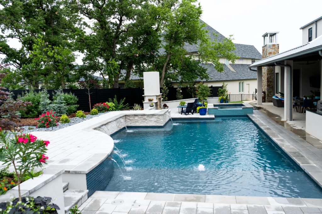 22x40 geometric pool with raised spa and paver deck in Oak Tree East Edmond Oklahoma.