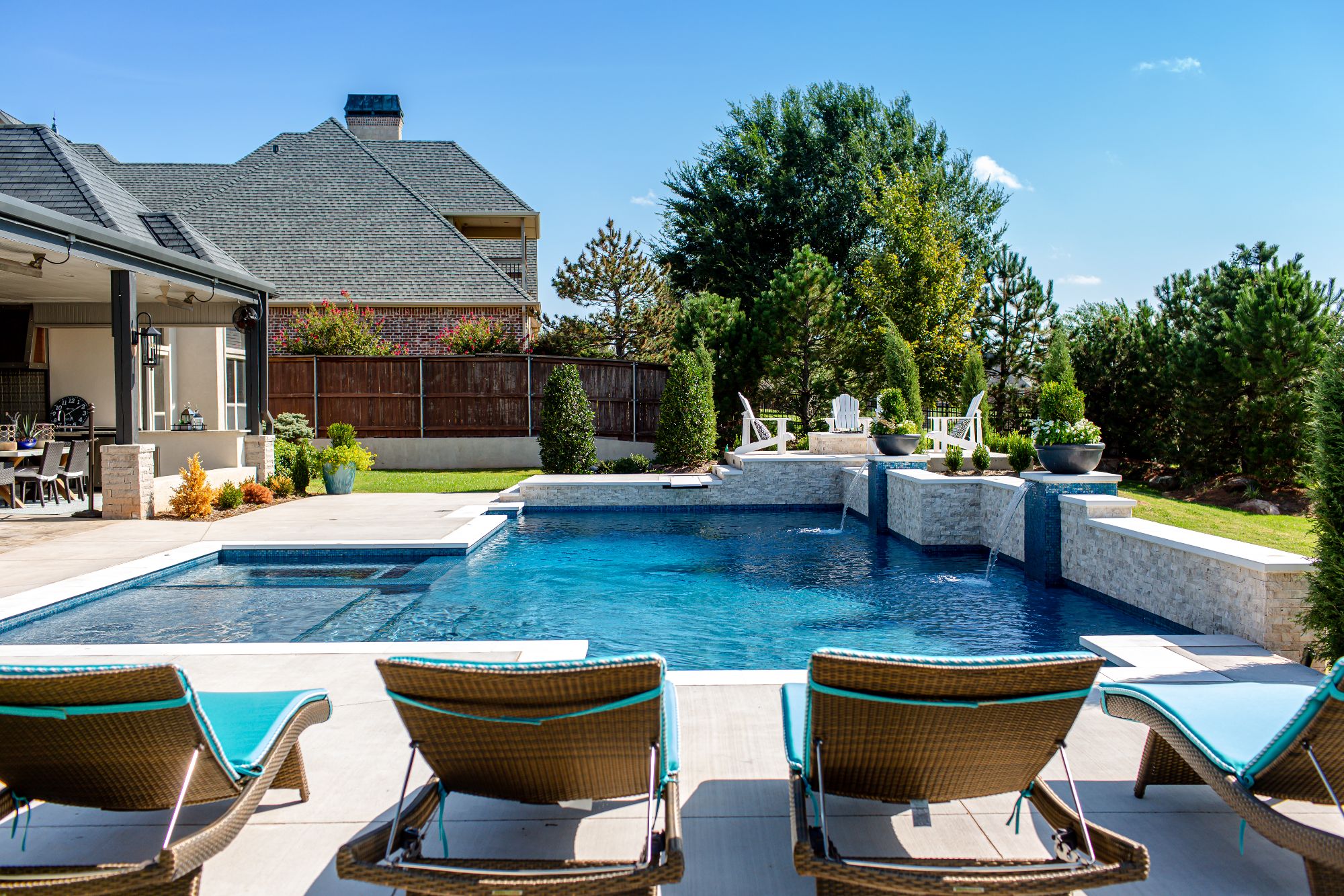 Geometric pool, 17x47 with flush spa and elevated fire pit / lounge seating in Rose Creek Edmond Oklahoma.