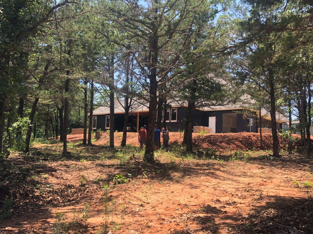 Wooded backyard lot in The Falls Jones Oklahoma before pool construction.