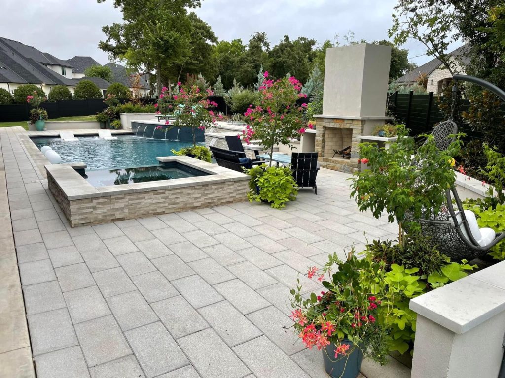 Geometric pool with raised spa and outdoor fireplace in Oak Tree East Edmond Oklahoma.