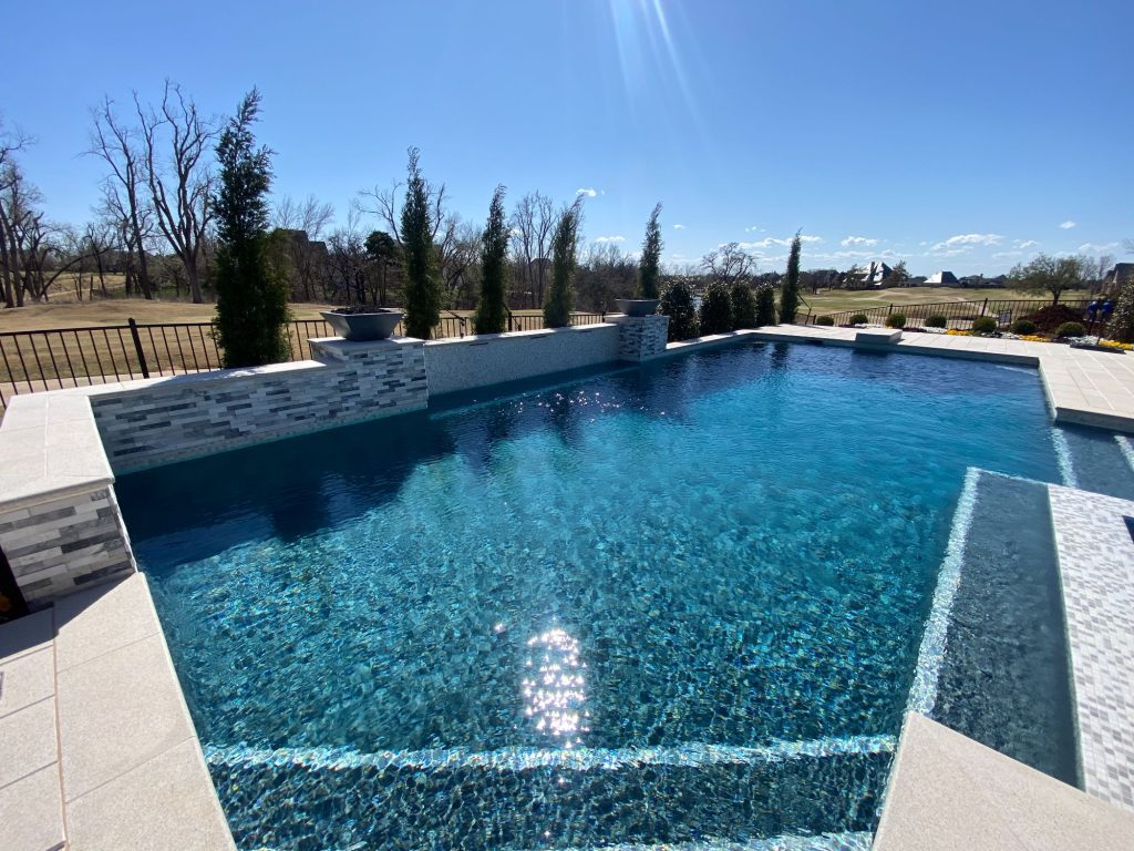 Midnight Blue ecoFINISH interior with Opal Pearl mosaic tile waterline in Edmond Oklahoma geometric pool.