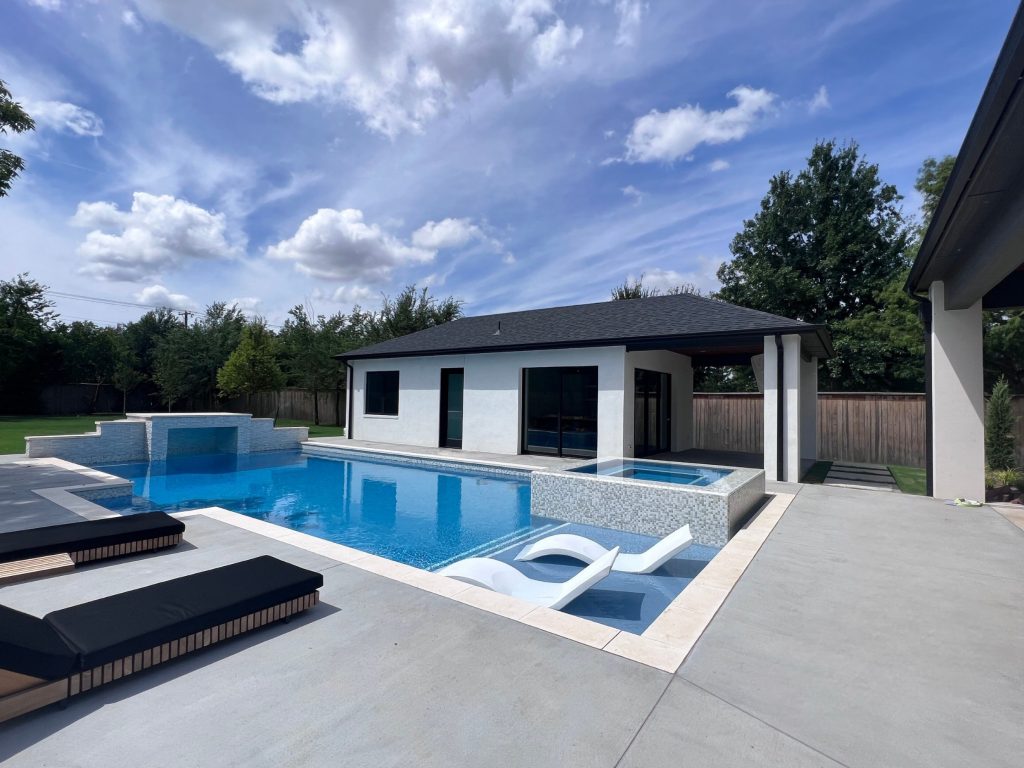 Geometric pool with tanning ledge and new pool house in Oklahoma City Oklahoma.